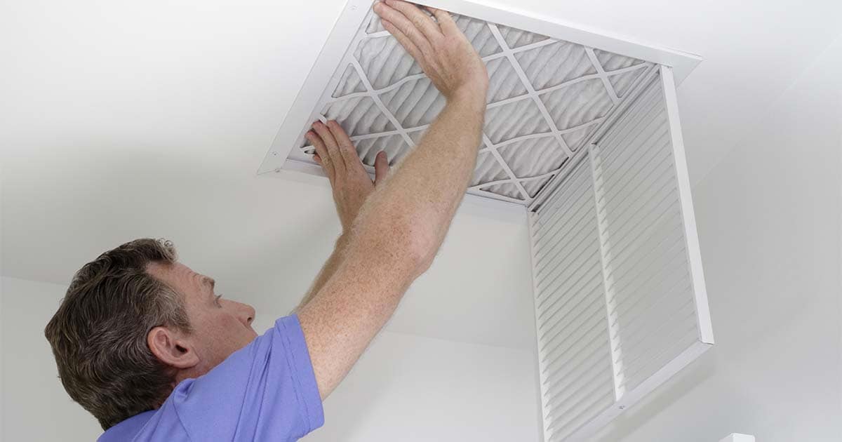 man changing air filter